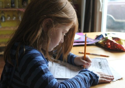 Child writing on paper