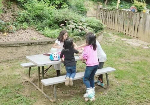 Four children take a break from school by playing together outdoors