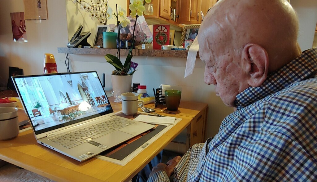 Charles Joy looks at laptop on kitchen table deplaying durable human quality of adaptivity


