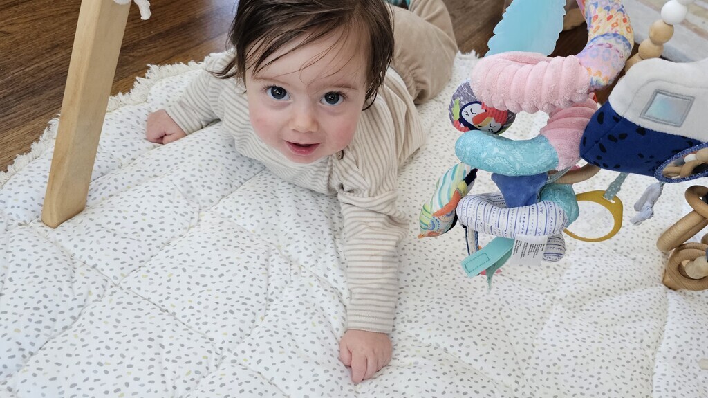 Baby on play mat looks up